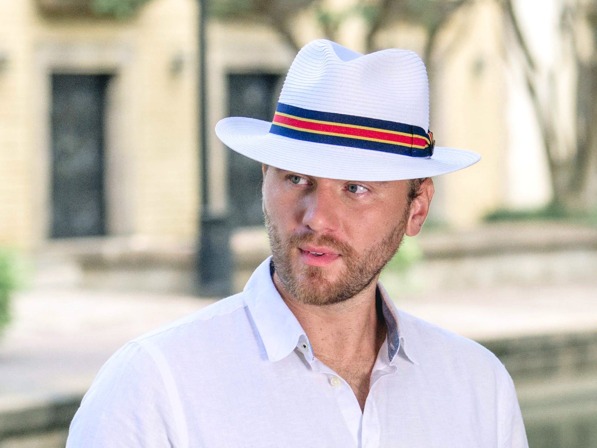 White paper braid fedora-style hat with multicolor striped band