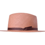 Pink woven Panama hat with dark brown band, side profile view.
