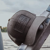 Dark trucker cap close-up on the side with raised STLHD logo patch