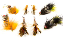 Assorted crawfish-style fishing flies with orange, brown, and green feather bodies