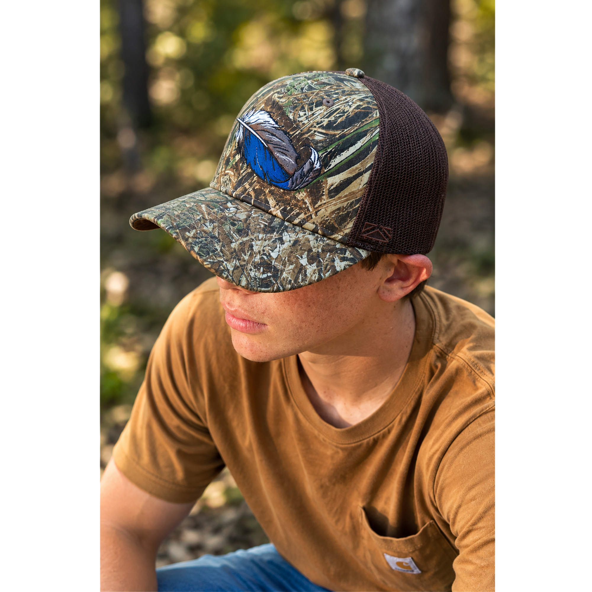 Duck-feather riverside cap worn by a person; bottomland camo with brown mesh back