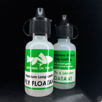 Fly floatant bottles, white with green labels and black ribbed caps
