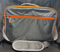 Gray travel reel case with orange trim, front zipper pocket, and carry handle loops