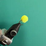 Chartreuse fuzzy fishing lure with looped hook
