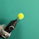 Chartreuse fuzzy fishing lure with looped hook