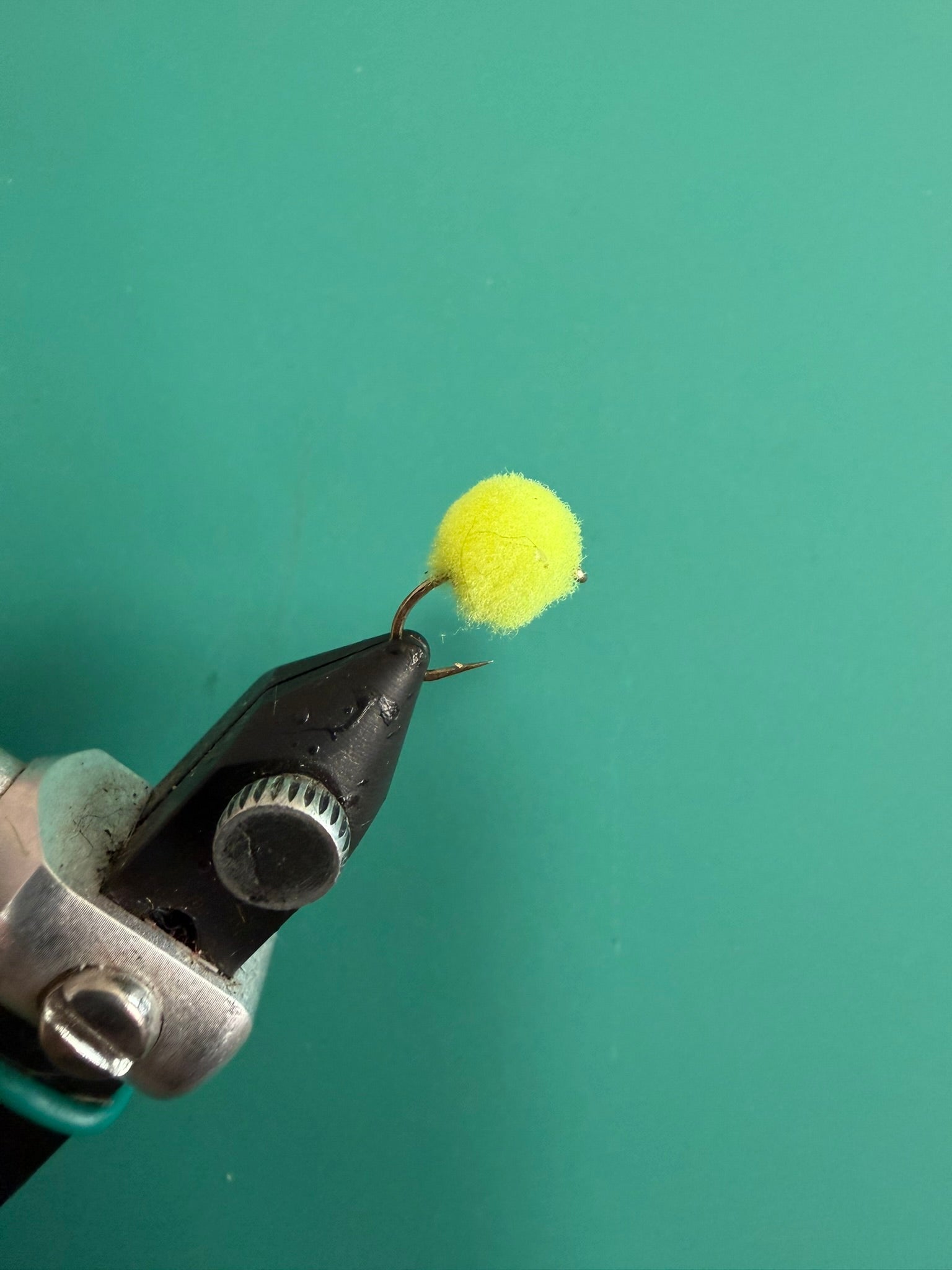 Chartreuse fuzzy fishing lure with looped hook
