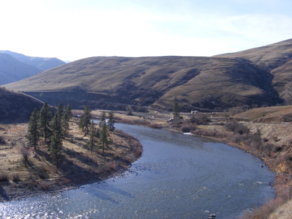 Mountain river landscape with banks and a winding stream
