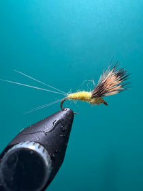 Fishing fly lure with dark head and yellow-green sulfur style fibers