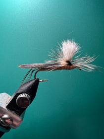 Parachute hopper fishing fly with black body and pink-tipped white fibers