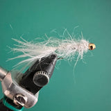 White leech fly with tungsten bead and barbless hook, gold bead and fuzzy tail
