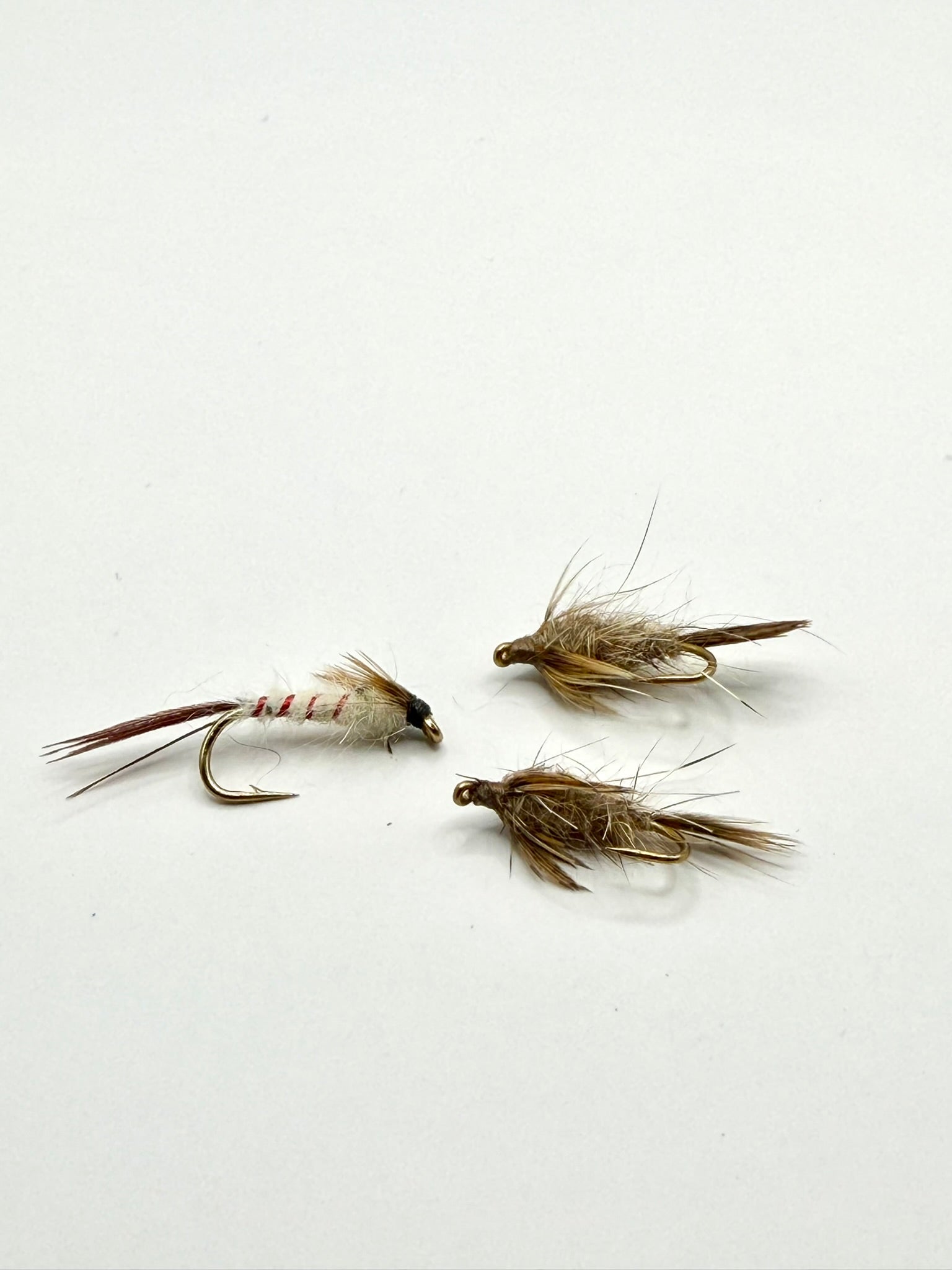 Set of three brown feather fishing flies with gold hooks