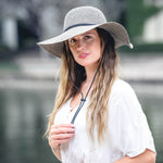 Stone poly braid wide-brim hat on model, with black band and chin cord.