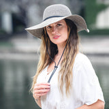 Stone poly braid wide-brim hat on model, with black band and chin cord.