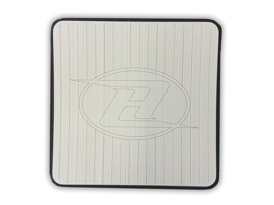 Square deck grip patch with vertical ridges and oval logo, off-white/cream.