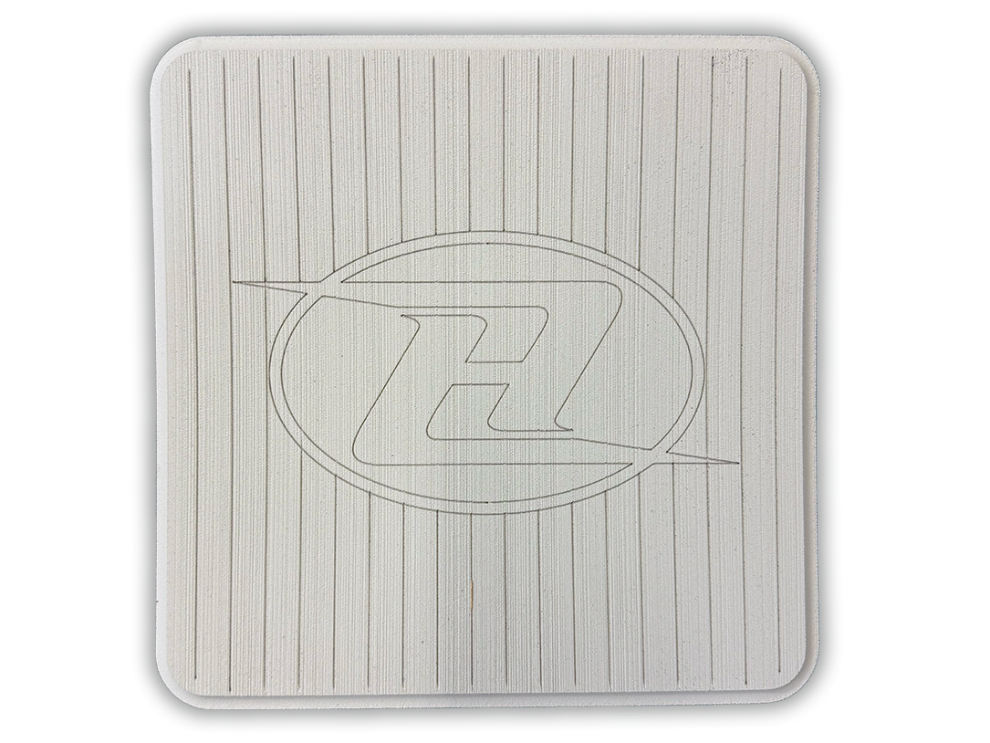Square deck grip patch with vertical ridges and oval logo, off-white/cream.
