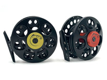 Black fly fishing reel with perforated spool and yellow/olive center plate