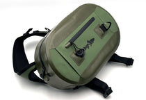 Olive waterproof sling pack with top handle, black straps, and front zip pocket.