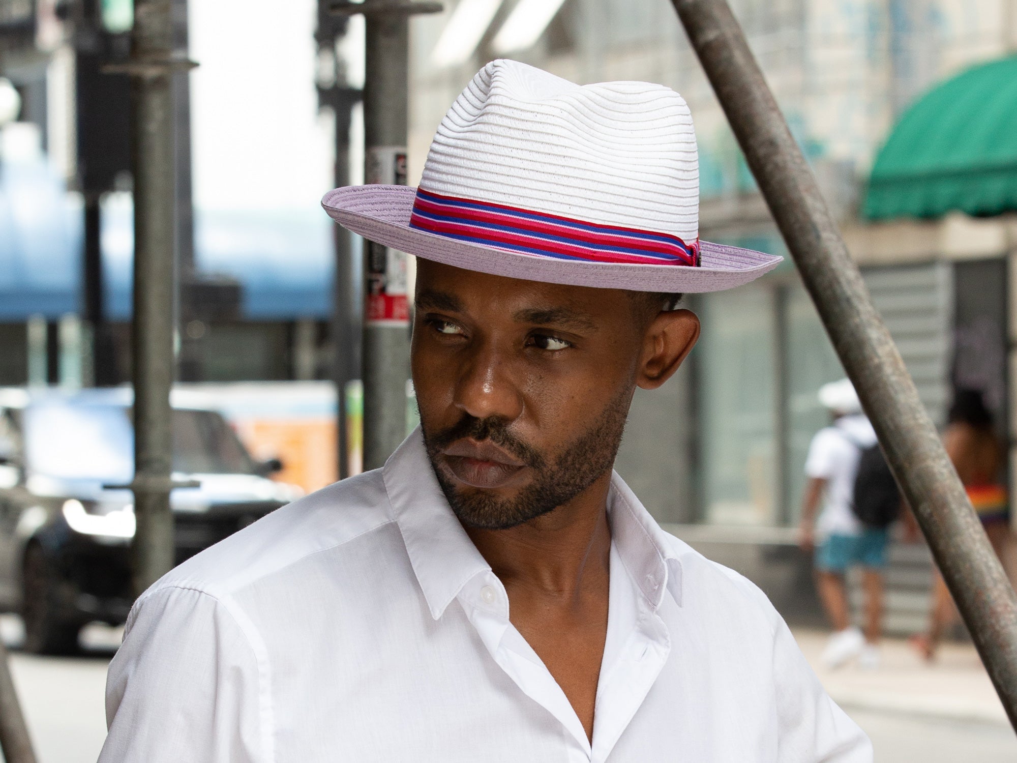 Lavender paper braid hat with multicolor striped band worn by model