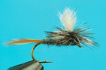Mayfly dry fly with cream wing tuft, dark body, on metal hook