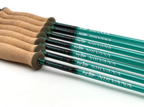 Fiberglass fly fishing rod with teal green blank and cork handle, multiple pieces