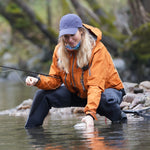 Bead-head nymph fly on line while angler wades in stream