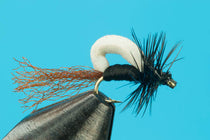 Foamback streamer fly with black body, white foam back, feather tail and hackle