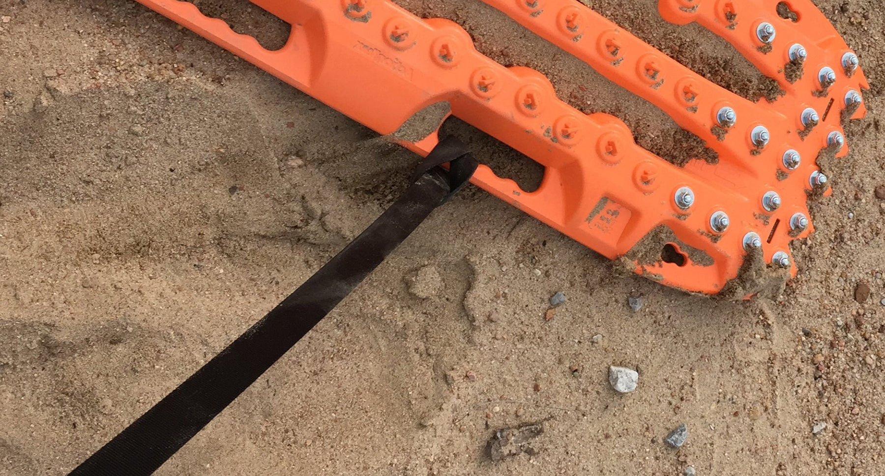 Orange recovery leash strap with black handle and eyelet on orange bar