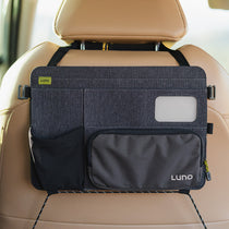 Dark gray seatback organizer with clear phone pocket, side pouches, and Luno patch