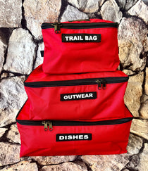 Storage cube set with three red utility bags, black trim, labels TRAIL BAG, OUTWEAR, DISHES