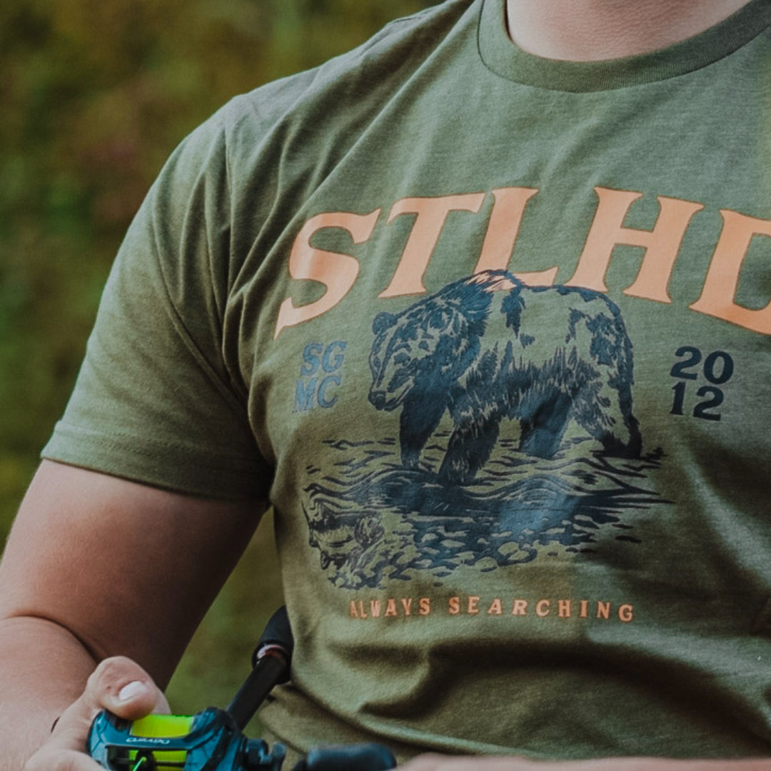 Olive STLHD grizzly bear t-shirt worn outdoors, front print visible