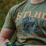 Olive STLHD grizzly bear t-shirt worn outdoors, front print visible