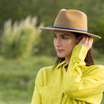 Merino wool felt hat in camel on model, with blue band and bow detail