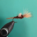 Shaving brush with tan bristles and a dark brown handle