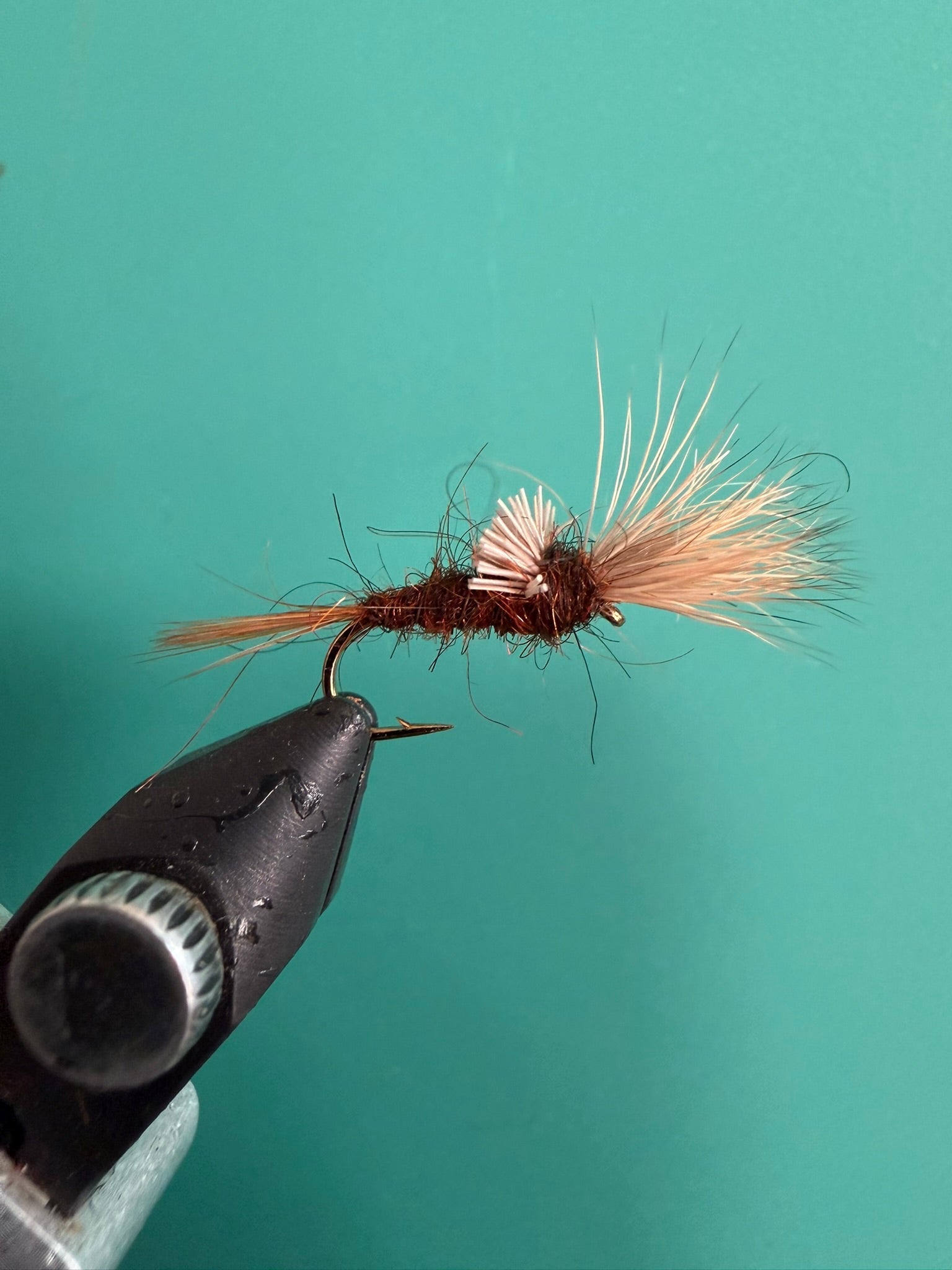 Shaving brush with tan bristles and a dark brown handle