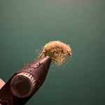 Brown sowbug figurine detail with fuzzy bristled texture and small legs
