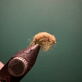 Brown sowbug figurine detail with fuzzy bristled texture and small legs