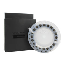 Fly fishing line spool with white line and dark loop accents, beside a black box.