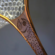 Wooden landing net handle with engraved brook trout and bronze-toned rim