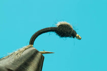 WD-40 fuzzy black chenille fishing streamer fly on curved hook