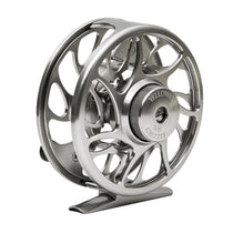 Silver fly fishing reel with cutout spokes, textured center cap, and stand