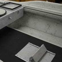 Adjustable foot brace shown from the side, metal frame with hinged support