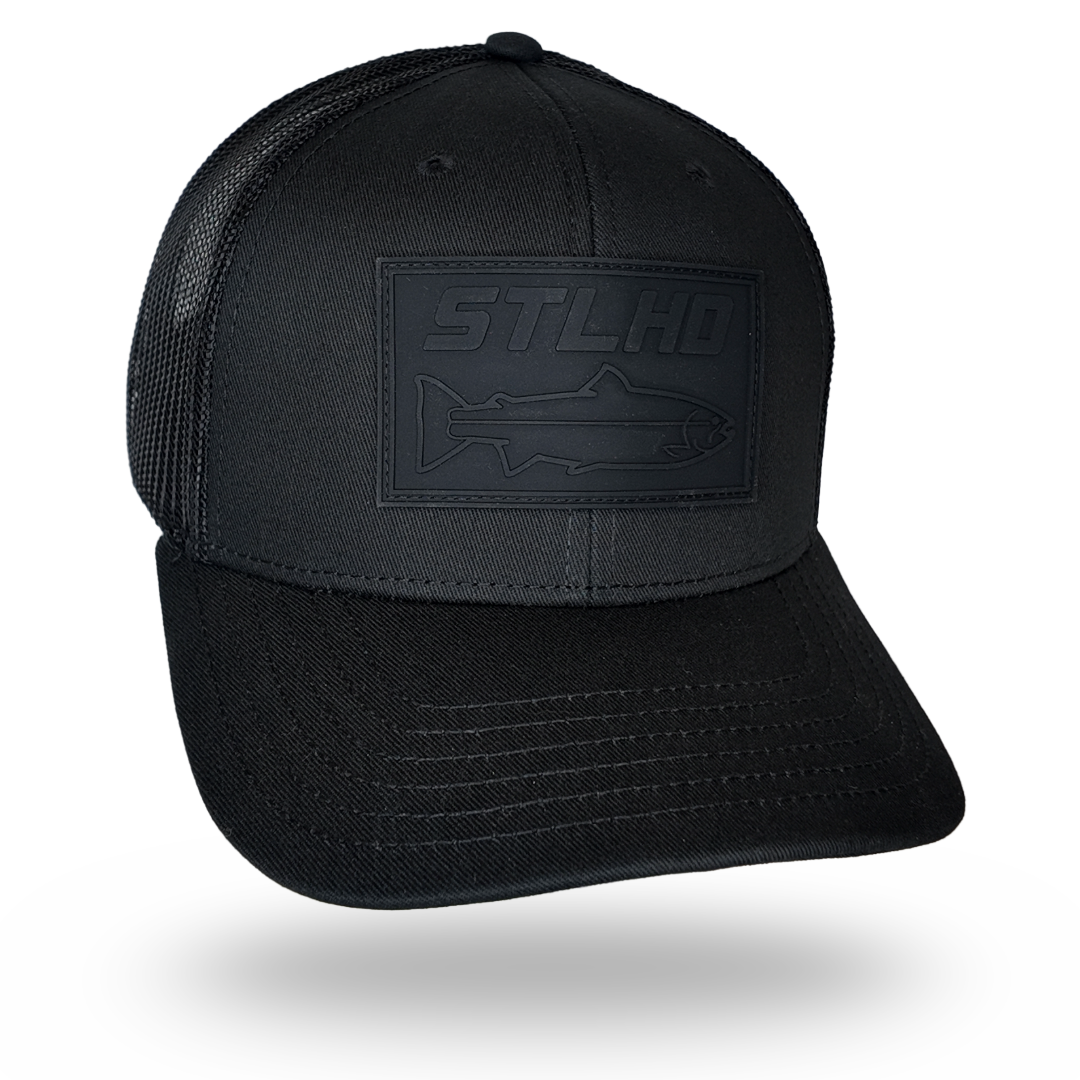 Black trucker cap with raised STLHD logo patch on the front panel