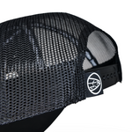 Black mesh trucker cap back with adjustable strap and circular logo patch