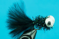 Feather lure with black plume and white pom-pom, metallic cone head