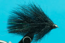 Black streamer fly with cone head and fuzzy legs