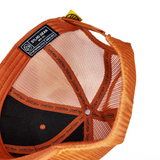Orange and black cap interior with mesh lining, button closure, and gear label