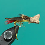 Weighted black fishing fly with metallic wing and red accent feathers