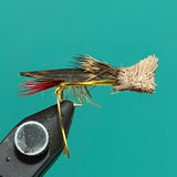 Weighted black fishing fly with metallic wing and red accent feathers