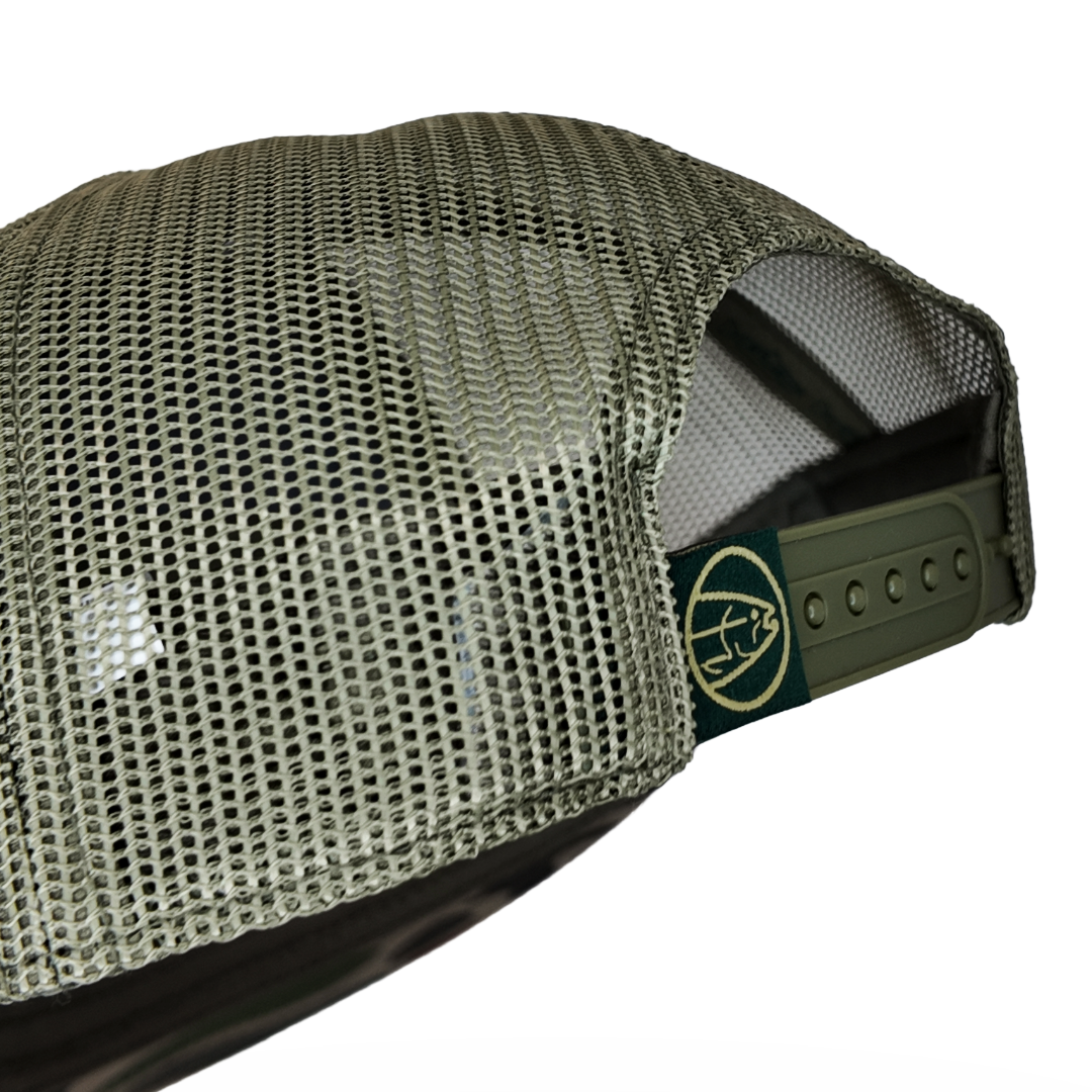 Olive mesh trucker cap side with snapback strap and circular logo patch