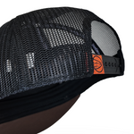 Trucker cap back panel with black mesh and orange brand tab on strap